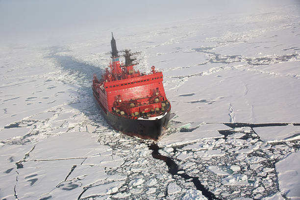 A red nuclear ice breaker ship in iceberg water Russian nuclear ice breaker heading to the North pole through pack ice, aerial shot from helicopter arctic stock pictures, royalty-free photos & images