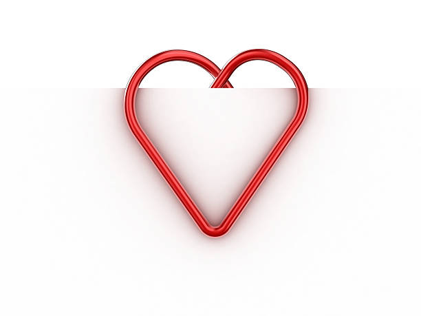 Red paper clip turned into a love heart stock photo