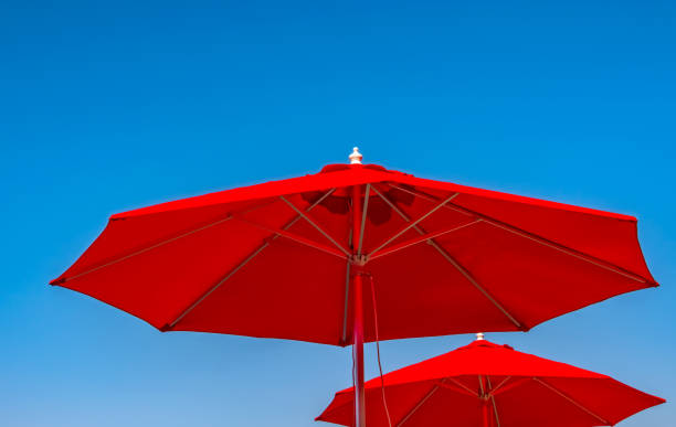 Red Parasols against a Clear Blue Sky stock photo