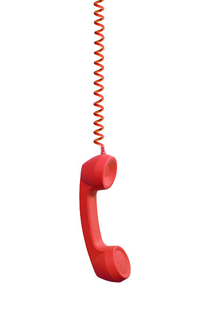 Red phone receiver hanging, isolated on white background stock photo