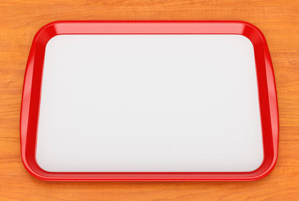 Red plastic food tray with empty liner Red glossy plastic fast food tray with blank white advertising paper liner on wooden table surface. 3D illustration tray stock pictures, royalty-free photos & images