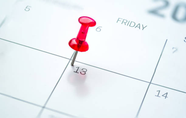 Red push pin on calendar Red push pin on calendar friday the 13th day of the month friday the 13th stock pictures, royalty-free photos & images