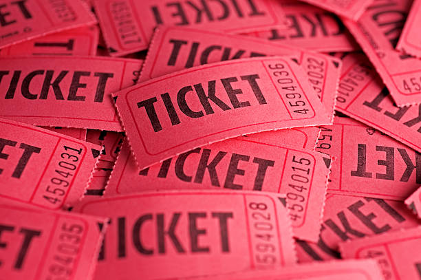 Red raffle tickets scattered and piled up on one another stock photo