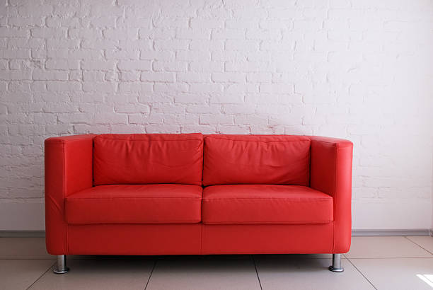 Red sofa and white brick wall stock photo