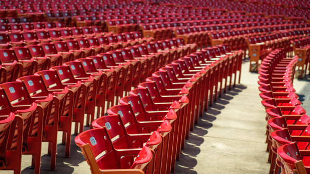 Red stadium chairs in an empty stadium. Empty Red stadium chairs. Empty seats in a stadium. The new normal. postponed stock pictures, royalty-free photos & images