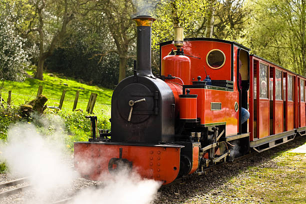 Red steam train from the front moving whistle in action stock photo