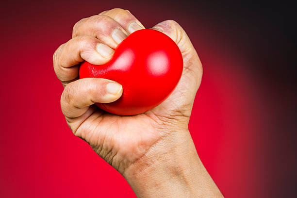 Red stress ball in hand stock photo