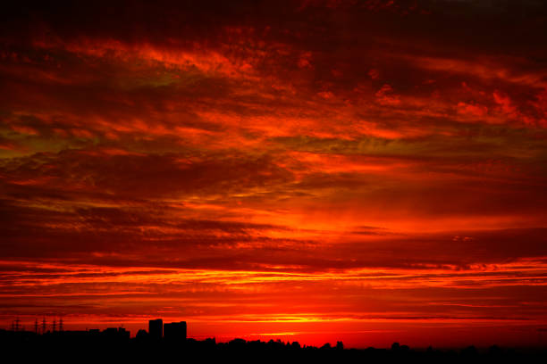 Photo of Red sunset over the city. Black red abstract background. Dramatic sky. Dark red horror background.
