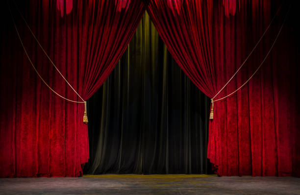 Red Theatre Curtain Red open theatre curtain with gold tassels agains a black curtain. theatrical performance stock pictures, royalty-free photos & images