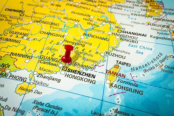 Red thumbtack in a map, pushpin pointing at Shenzhen stock photo