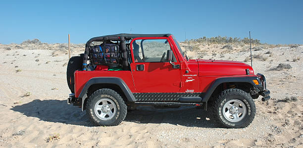 Red TJ Jeep Wrangler driving near the Coorong, South Australia stock photo