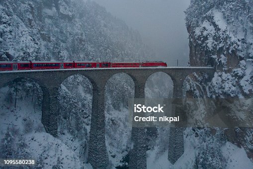 istock Red Train Glacier exoress in the blizzard over Landwasserviadukt in Switzerland 1095580238