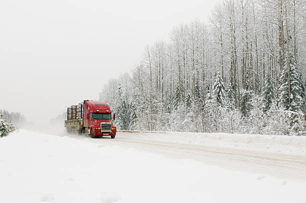 red truck on winter road stock photo