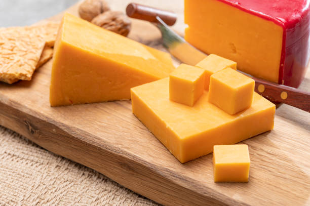 Red waxed yellow cheddar cheese close up stock photo