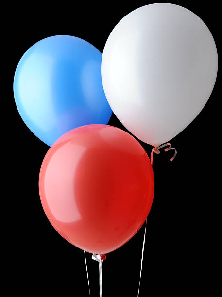 Red, White and Blue Helium Balloons Isolated on Black Background stock photo