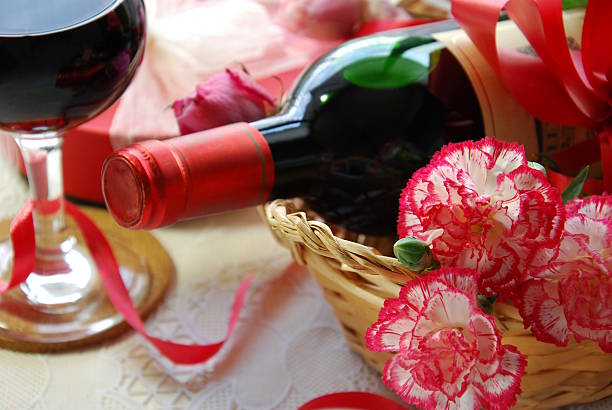 red wine and carnation flowers for celebration stock photo