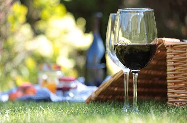 Wine glasses and hamper picnic scene
