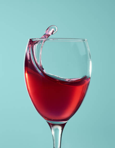 Red wine splashing in a glass stock photo