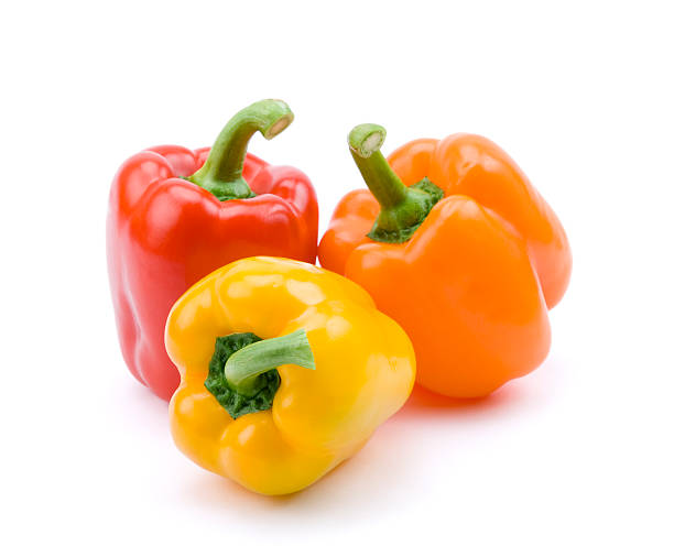 Red, yellow, and orange bell peppers Three bell peppers isolated on white. pepper vegetable stock pictures, royalty-free photos & images