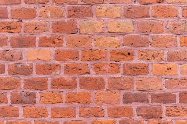 Redbrick wall with pinkish joints. Full frame background or banner stock photo