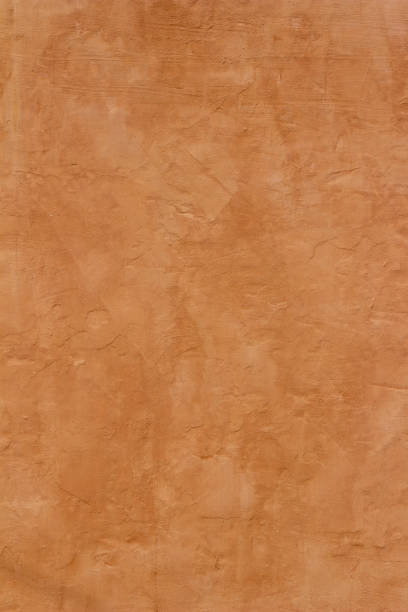 Reddish brown adobe style wall texture Abstract background of an exterior reddish brown adobe style wall surface texture. adobe backgrounds stock pictures, royalty-free photos & images