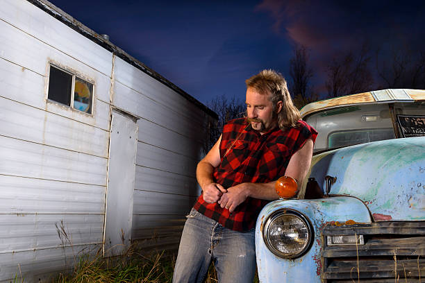 Redneck Thinking and Worried While Down on His Luck "Man with pensive, anxious, worried expression doing some thinking outdoors next to trailer" mullet haircut stock pictures, royalty-free photos & images