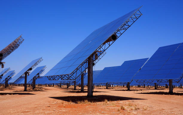 Reflective panels in a solar thermal power plant, blue sky stock photo