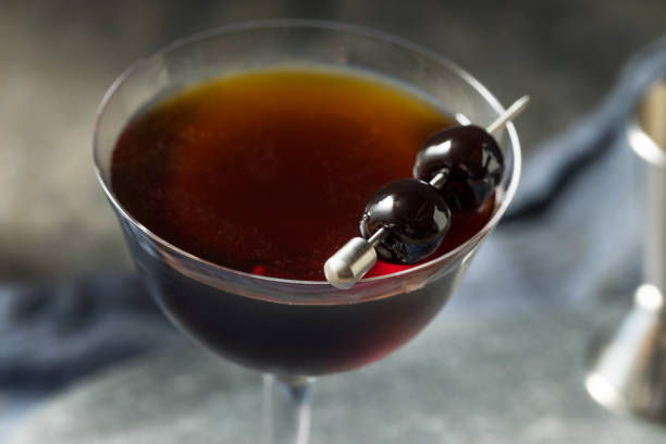 Refreshing Boozy Black Manhattan Cocktail Refreshing Boozy Black Manhattan Cocktail with Amaro and Rye manhattan cocktail stock pictures, royalty-free photos & images