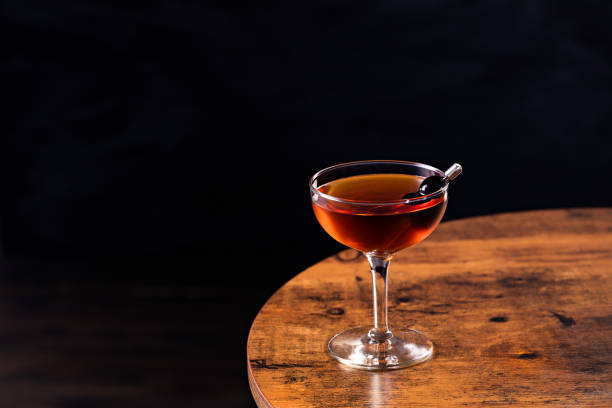 Refreshing Bourbon Manhattan Cocktail Refreshing Bourbon Manhattan Cocktail on a Table manhattan cocktail stock pictures, royalty-free photos & images