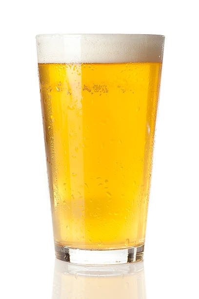 Refreshing Ice Cold Beer Refreshing Ice Cold Beer against a background pint glass stock pictures, royalty-free photos & images