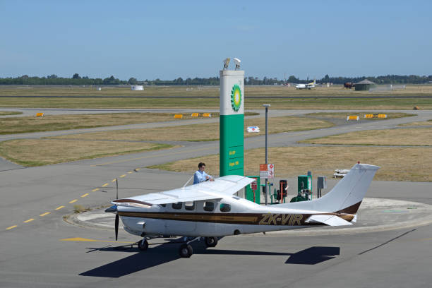 refueling time Christchurch, New Zealand, December 12, 2014: The unidentified pilot of a light plane refuels his plane at Christchurch International Airport on December 12, 2014 bowser stock pictures, royalty-free photos & images