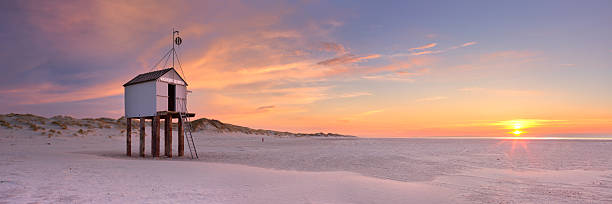Refuge hut on Terschelling island in The Netherlands at sunset stock photo