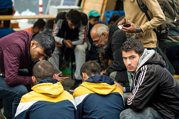 Refugees in train station stock photo