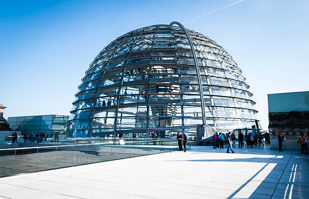 Reichstag glass dome Berlin, Germany - March 23, 2012: Reichstag glass dome construction above German parliament (Bundestag). Construction of cupola (designed by architect Norman Foster) was finished in 1999, the seat of Bundestag was transfered here also same year. People visiting the monument on the rooftop. cupola stock pictures, royalty-free photos & images