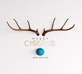 istock Reindeer with blue nose with Merry Christmas text on white background 1345355469