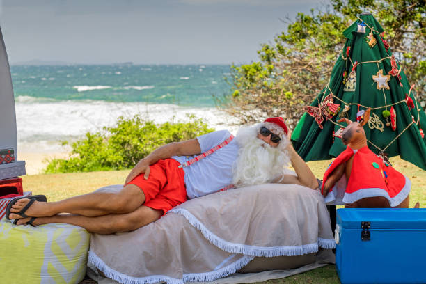 Relaxed Santa Claus lying on the beach stock photo