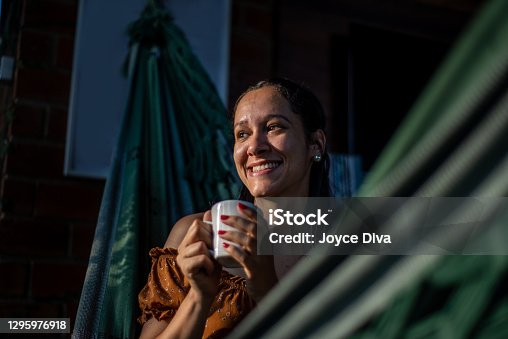 istock Relaxed young woman having a cup of coffee 1295976918