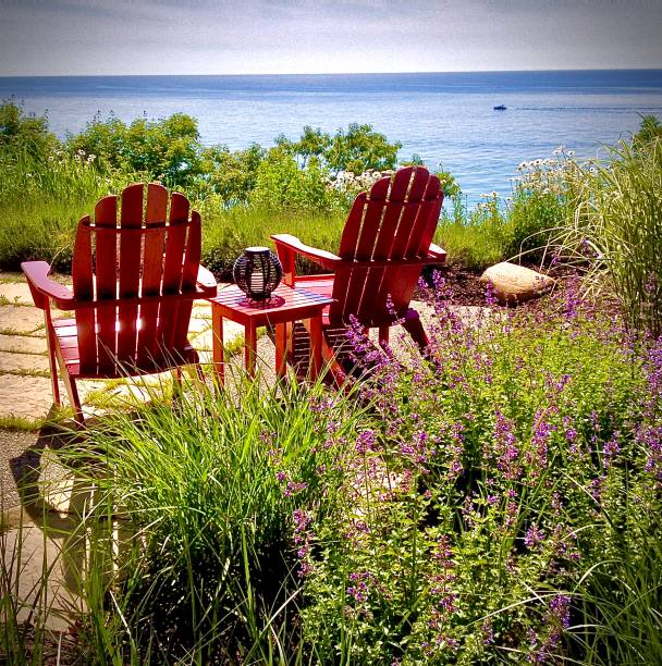 Relaxing Chairs Facing a Midwest Lake A summer afternoon relaxing in chairs by a beautiful Midwest lake lakeshore stock pictures, royalty-free photos & images