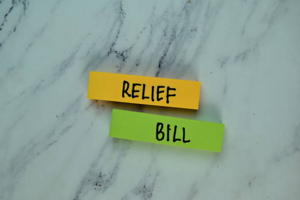 Relief Bill write on sticky note isolated on Wooden Table. Financial concept Relief Bill write on sticky note isolated on Wooden Table. Financial concept relief carving stock pictures, royalty-free photos & images
