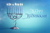 istock Religion image of jewish holiday Hanukkah background with menorah (traditional candelabra) and candles 1283805656