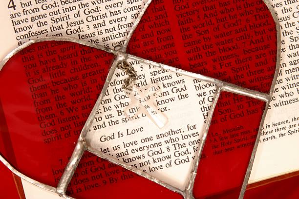 Religious: Bible Scripture God is Love with stained glass heart stock photo