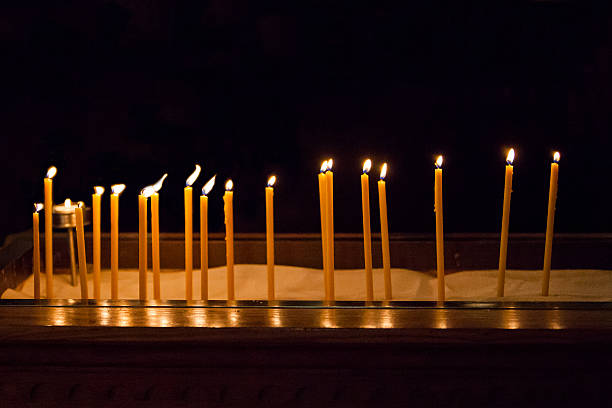 Religious Candles in Darkness stock photo