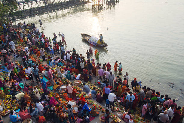 Religious Festival Сalcutta,India - November 12, 2010: Indian Hindu Devotees pay obeisance to both the rising and the setting sun in the Chhath Puja festival , when people express their thanks and seek the blessings of the forces of nature, mainly the Sun and river. In this occasion crowed gatherings for holy bath. chhath stock pictures, royalty-free photos & images