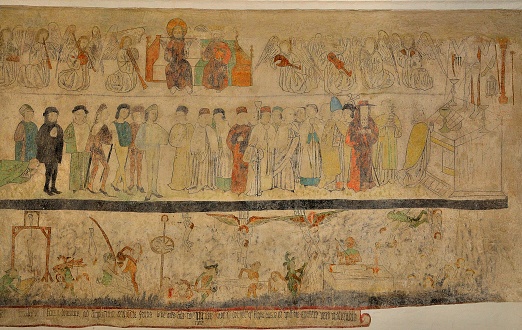A recovered ancient fresco on display at the Aarhus Cathedral in Denmark, used to educate people who could not read, depicting the Christian concept of heaven, earth and hell, top to bottom. 
Aarhus Cathedral's walls were originally covered with murals, but during the Reformation, they were whitewashed. Gradually several of the paintings have been been uncovered. Despite the loss, it is the church in Denmark that has the largest area of frescoes.