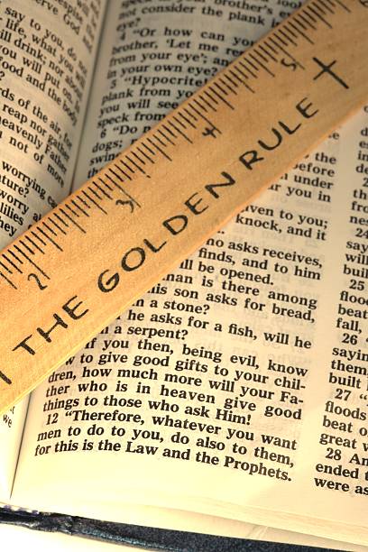 Religious: The Gold Rule Bible scripture with ruler vertical stock photo
