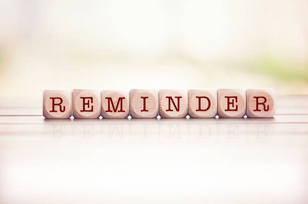 Reminder written on cube wooden blocks. Reminder word written on cube wooden blocks. Defocused background. reminder stock pictures, royalty-free photos & images
