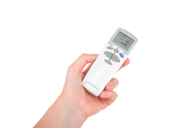 Remote control of air conditioner in hand stock photo