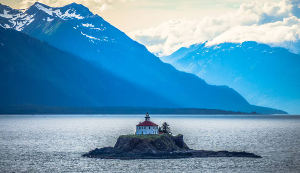 remote lighthouse island standing in the middle of mud bay alaska stock photo