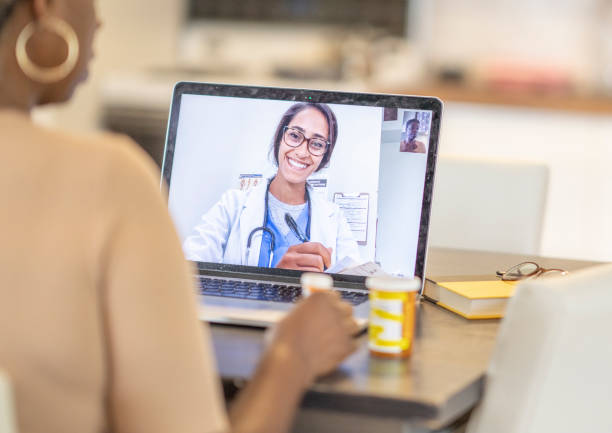 Remote medical appointment African American woman has medical consultation appointment video video call with her doctor. telemedicine stock pictures, royalty-free photos & images