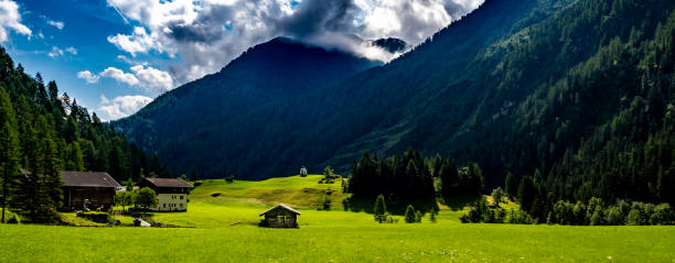 Remote Settlement And Small Chapel In Rural Landscape At Mountain Grossvenediger In Tirol In Austria stock photo